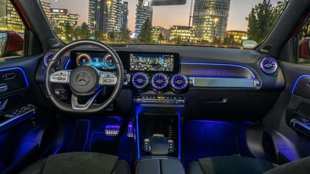 interior of Mercedes-Benz EQB 350 with beautiful blue lights and front large buildings view