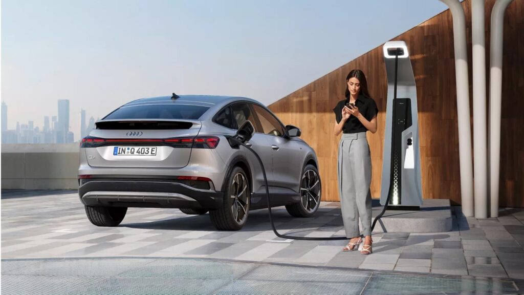 beautiful women charged Audi Q4 Sportback e-tron on the power station of Audi